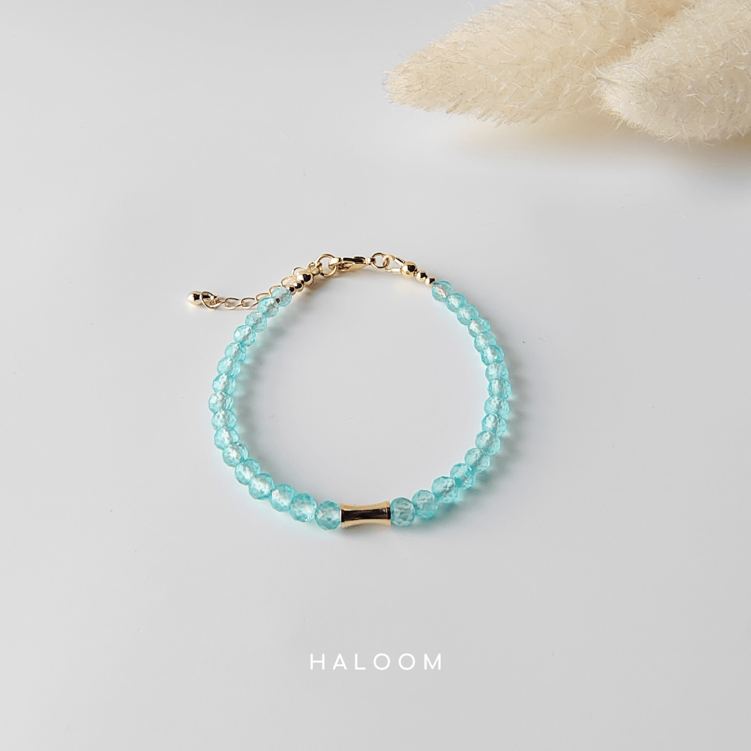 Blue topaz December birthstone bracelet with gold bar