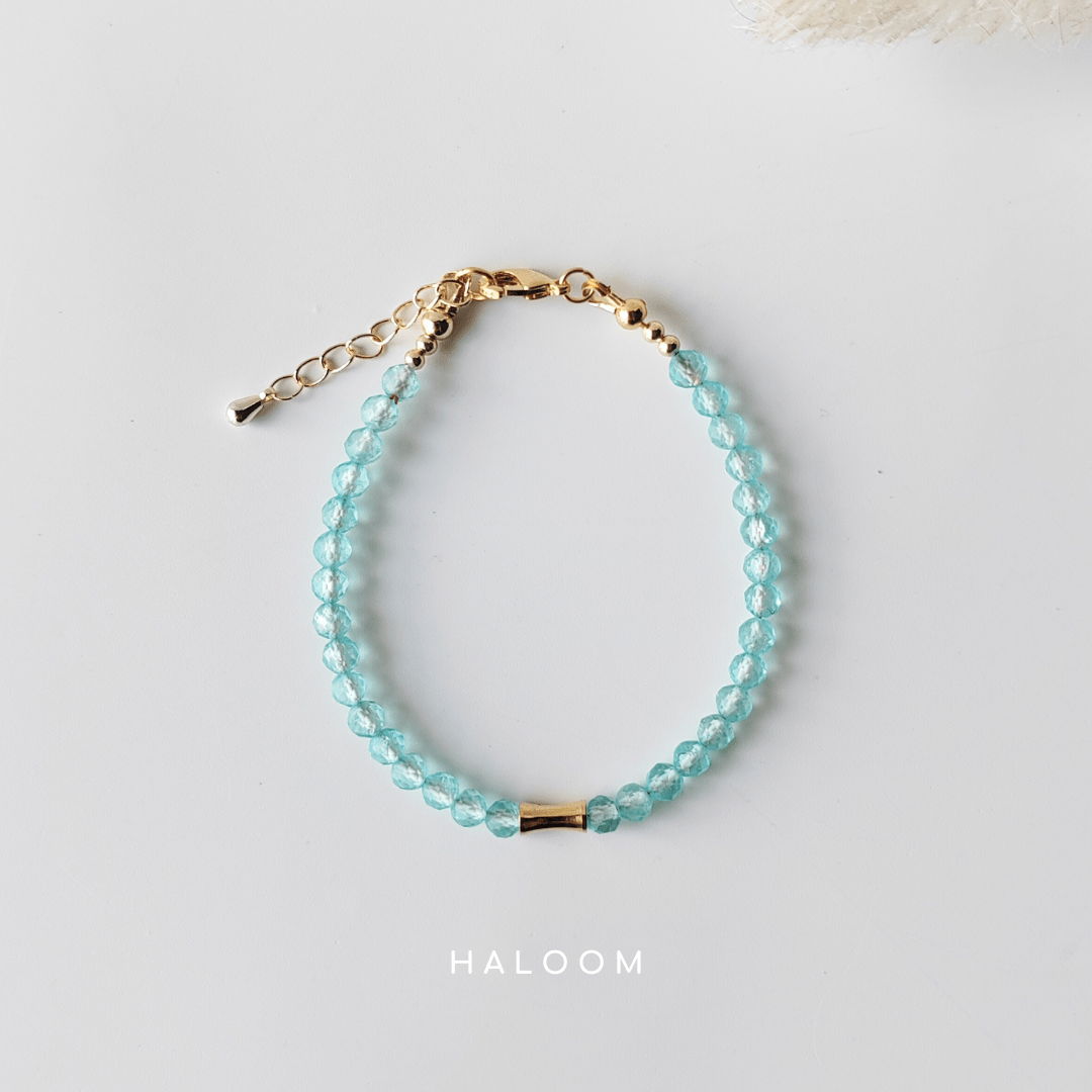 Blue topaz December birthstone bracelet with gold bar