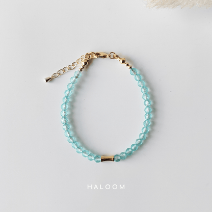 Blue topaz December birthstone bracelet with gold bar