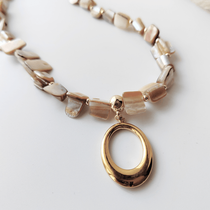 Natural shell necklace with stainless steel pendant.