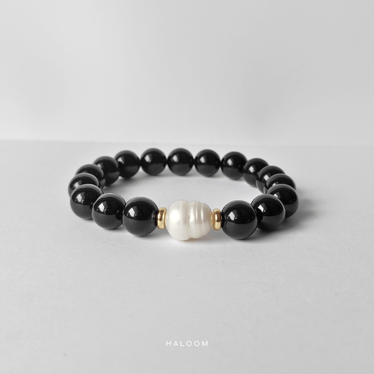 Grounded and calm black onyx with freshwater pearl
